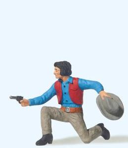 Cowboy kniend, mit Revolver