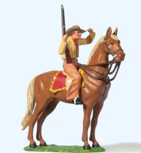 Cowboy zu Pferd, mit Gewehr